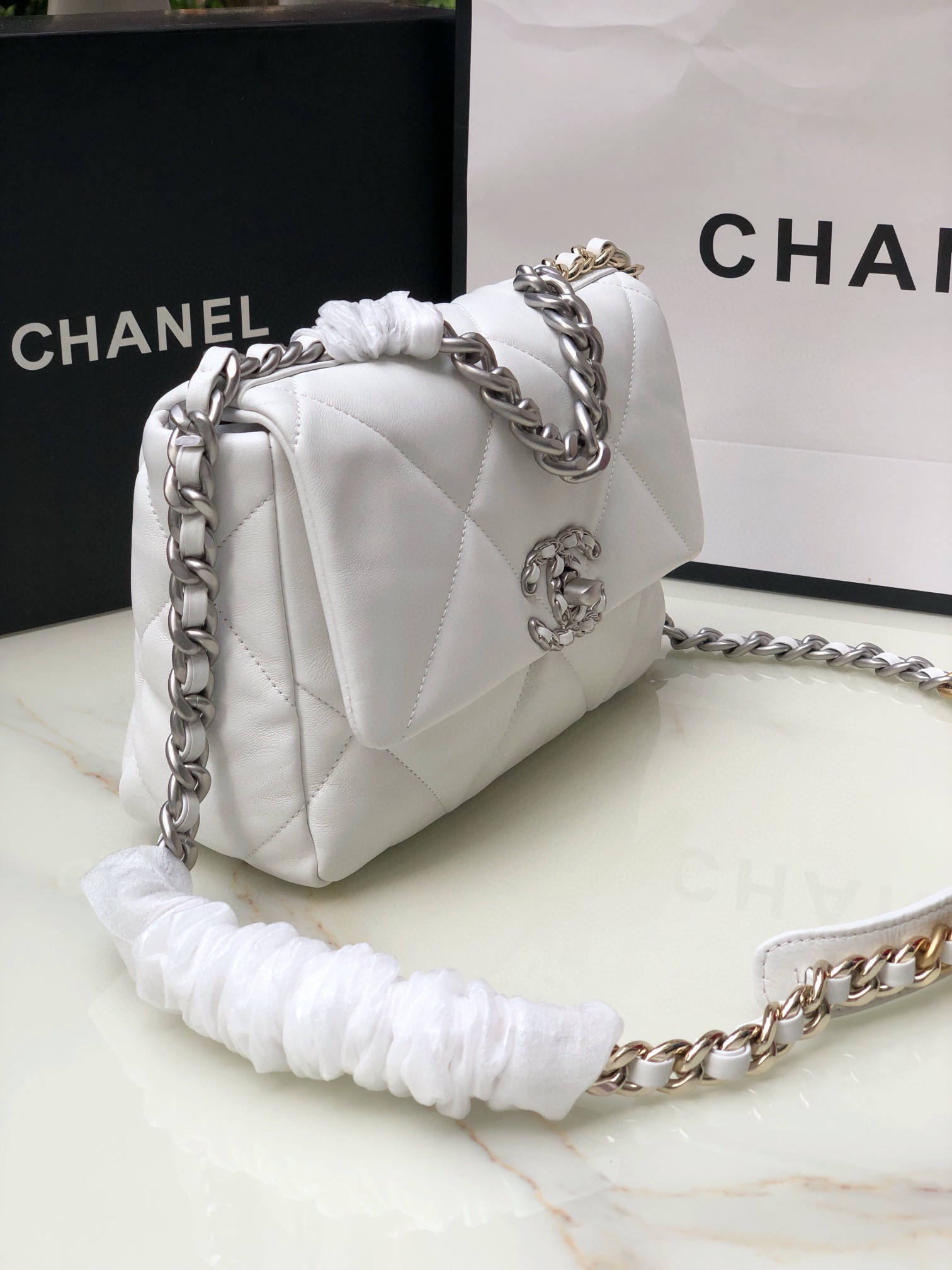Ch**el 19 HANDBAG Shiny Leather, Gold-Tone, Silver-Tone & Ruthenium-Finish Metal White 6.2 × 10.1 × 3.5 in